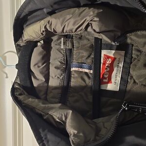 Black Military Field Jacket with Prominent Collar and Tailored Fit.